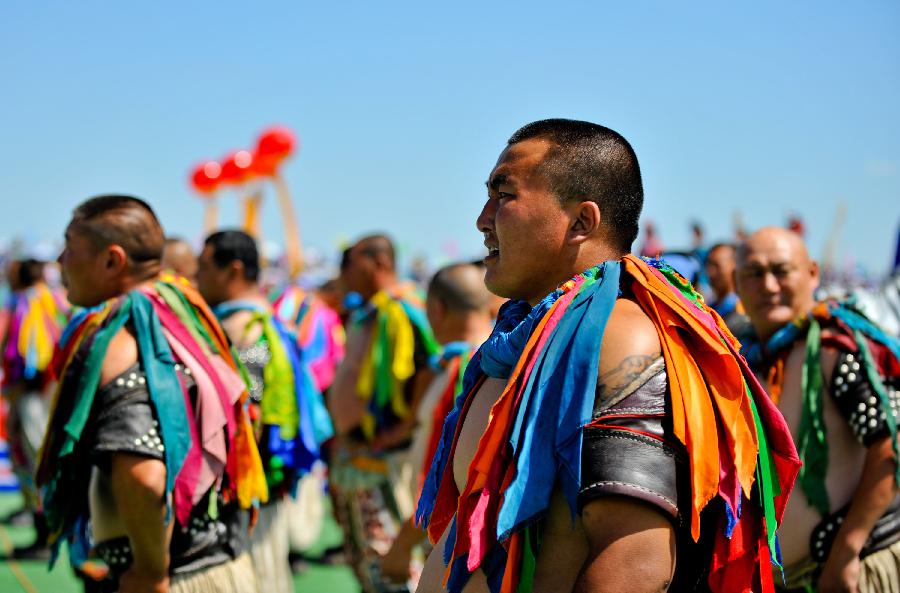 People perform during the opening of a Nadam fair in West Ujimqin Banner, north China's Inner Mongolia Autonomous Region, July 16, 2012.