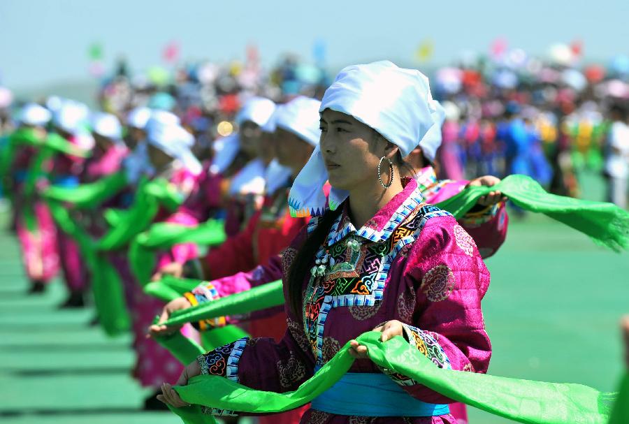 People perform during the opening of a Nadam fair in West Ujimqin Banner, north China's Inner Mongolia Autonomous Region, July 16, 2012.