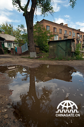 Photo shows a poor area in a big city, where the paupers find their accommodation even in the carton box. 