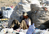 Two guys are sleeping around trash. Many families live around trash dump and live on picking up trash. [Photo was taken by a Mexican visual artist Victor Hugo. Casillas Romo in a trush dump at Zapopan, Mexico on July 22, 2011.]