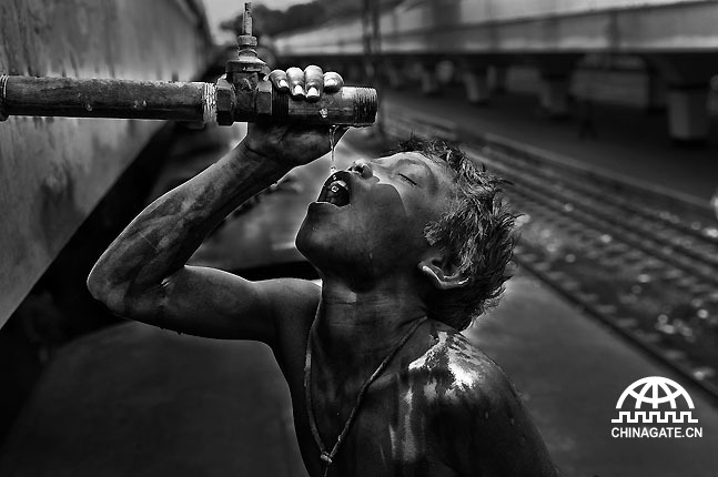 Poverty kills the basic right of pure drinking water. Khaled (13) is drinking water from a train cleaning water pipe on the roof of a train.