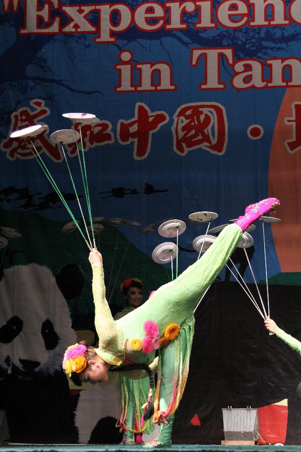 A Chinese acrobat performs Plate Spinning during the show 'Experience China' in Dar es Salaam, Tanzania, Sept. 24, 2012.