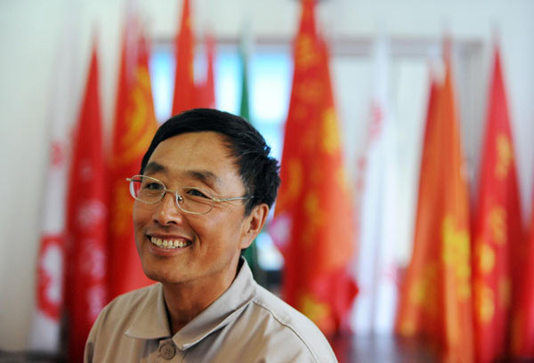 The 18th CPC National Congress delegate Guo Mingyi poses for a photo in Anshan, northeast China's Liaoning Province, Aug 21, 2012.