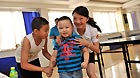 Cui Xiangqian, 42, plays with children at a community playroom in Guiyang, southwest China's Guizhou Province, Sept 10, 2012.