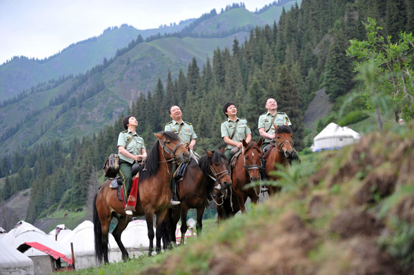 Zhuang Shihua, 2nd from left, leads a medical squad offering free medical consultation to people in a remote village in Urumqi, Xinjiang Uygur Autonomous Region, June 18, 2012.