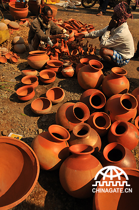 Small budget entrepreneurs buy and sell their earthen pots inside the Kenduli fairground. 
