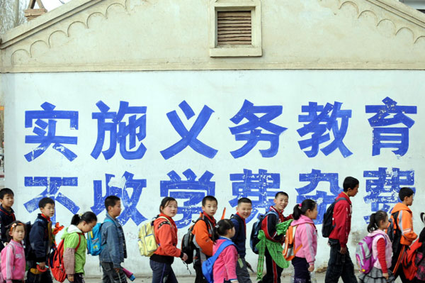 Primary students go home after school in Linze County, Gansu Province on March 13, 2008. 