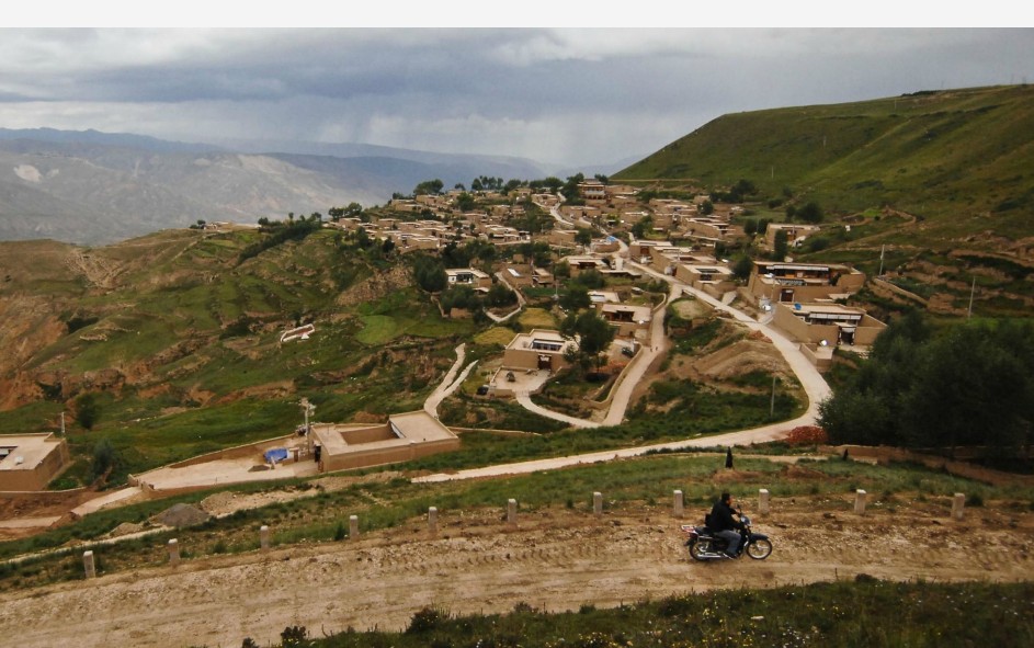 Nyima Tsering rides a motorcycle to visit famers in Jicang Village, Huangnan Tibet Autonomous Prefecture, Qinghai Province, Aug 22, 2012.