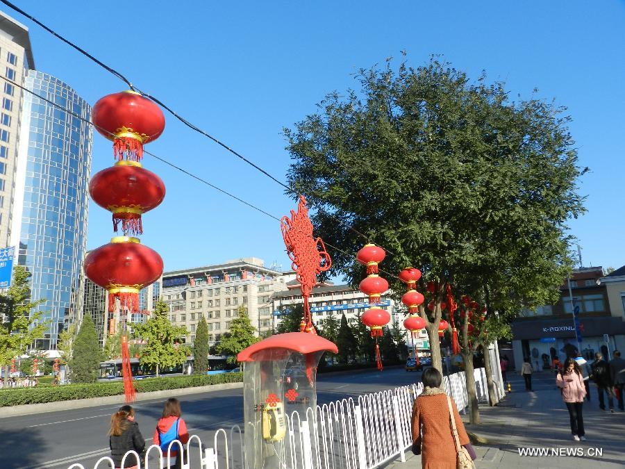 Red lanterns and banners are seen on the street to greet the upcoming 18th National Congress of the Communist Party of China (CPC) in Beijing, capital of China, Oct. 30, 2012. 