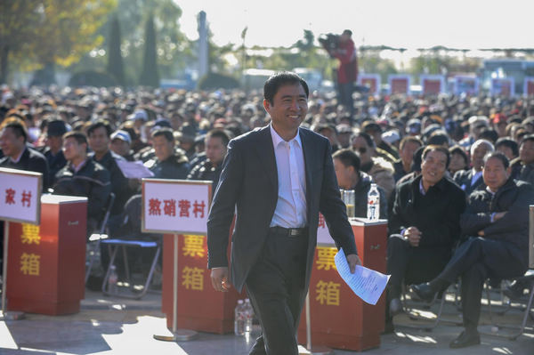 A village party secretary from Yongle County in Tongzhou District in Beijing prepares to deliver his work report to 5,000 village representatives, Oct 31, 2012.