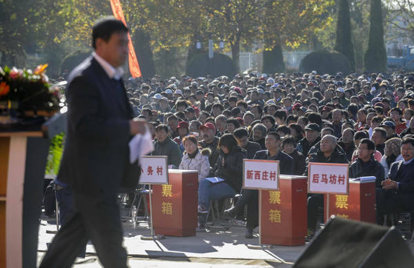 A village party secretary from Yongle County in Tongzhou District in Beijing prepares to deliver his work report to 5,000 villager representatives, Oct 31, 2012.