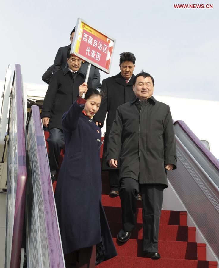 Hao Peng (R, front), a delegate of the 18th National Congress of the Communist Party of China (CPC) from Tibet Autonomous Region, arrives in Beijing, capital of China, on Nov. 5, 2012.