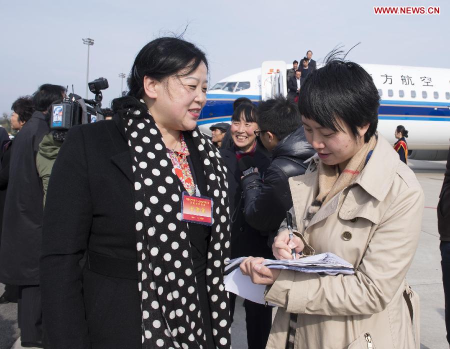 Lei Fang (L), a delegate of the 18th National Congress of the Communist Party of China (CPC) from Henan Province, is interviewed by Xinhua after arriving in Beijing, capital of China, Nov. 5, 2012. 