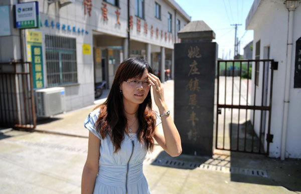 Zhong Yi walks out of the village committee building in Zhanfeng Village of Jiashan County, east China&apos;s Zhejiang Province, June 29, 2012. 