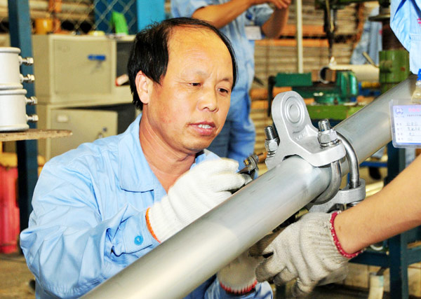 Ju Xiaolin works at a materials center for Jinqin Railway, Aug 14, 2012.