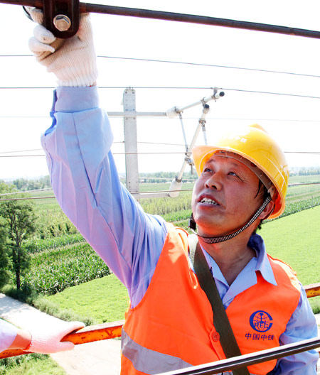 Ju Xiaolin inspects a contact wire Aug 16, 2012.