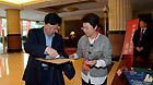 Li Qingkui (L), a delegate of the 18th National Congress of the Communist Party of China (CPC) from the delegation of state-owned enterprises, registers for the congress in Beijing, capital of China, Nov. 6, 2012.