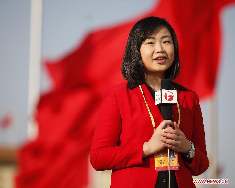 A news anchor from east China's Anhui Province conducts report at the Tian'anmen Square in Beijing, capital of China, Nov. 8, 2012. 