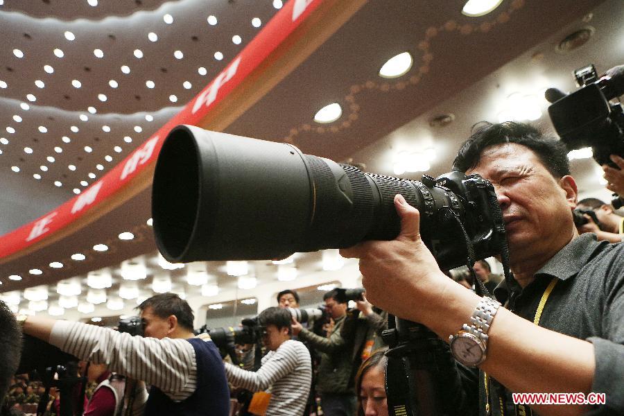 A photographer takes photos of the opening ceremony of the 18th National Congress of the Communist Party of China (CPC) at the Great Hall of the People in Beijing, capital of China, Nov. 8, 2012. 