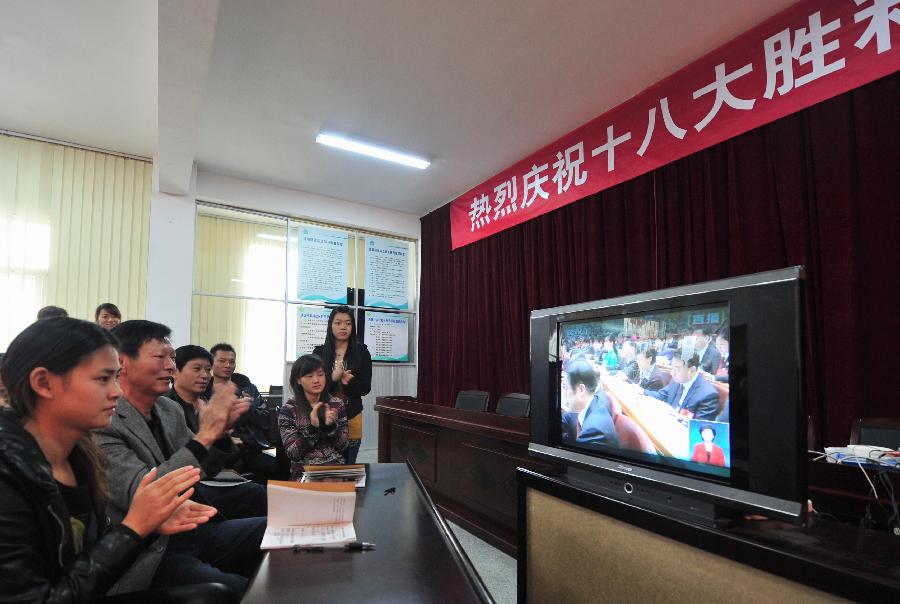 Local villagers watch TV reporting the opening ceremony of the 18th National Congress of the Communist Party of China (CPC) in Hongtian Village of southeast China's Fujian Province, Nov. 8, 2012.