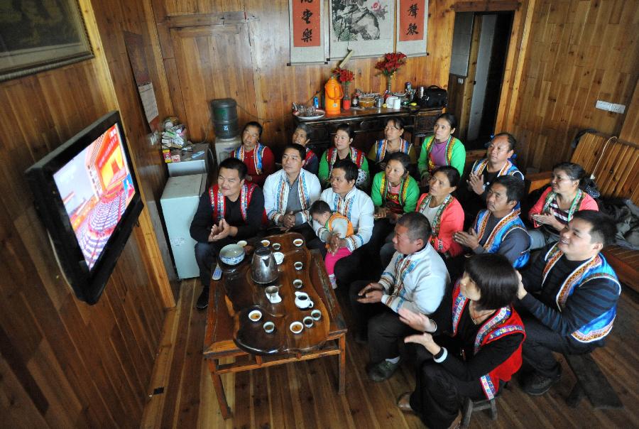 Local villagers watch TV reporting the opening ceremony of the 18th National Congress of the Communist Party of China (CPC) in Nanjiang Village of south China's Guangxi Zhuang Autonomous Region, Nov. 8, 2012. 