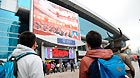 Passengers watch TV reporting the opening ceremony of the 18th National Congress of the Communist Party of China (CPC) at the railway station in Guiyang, capital of southwest China's Guizhou Province, Nov. 8, 2012.