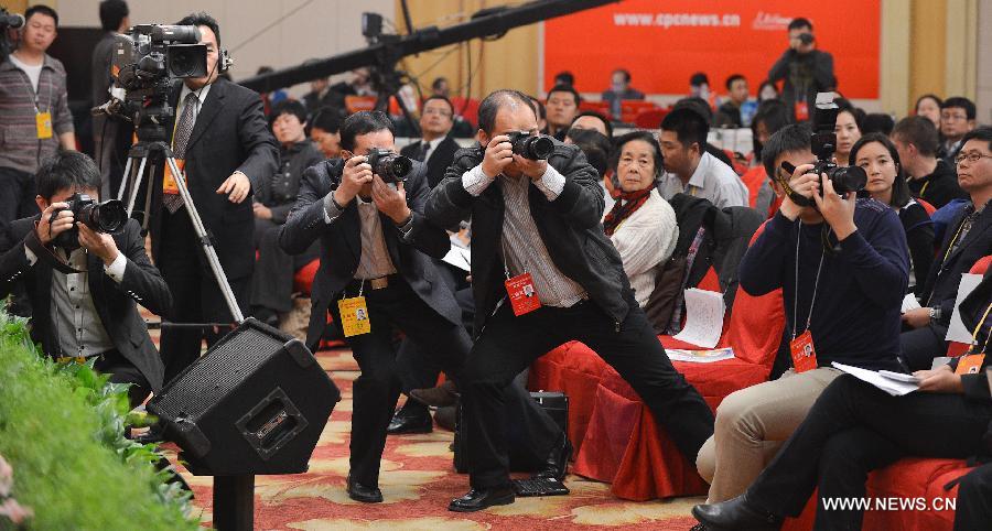 Photographers take photos at a press conference held by the press center of the 18th National Congress of the Communist Party of China (CPC) on CPC theory innovation, in Beijing, capital of China, Nov. 9, 2012.