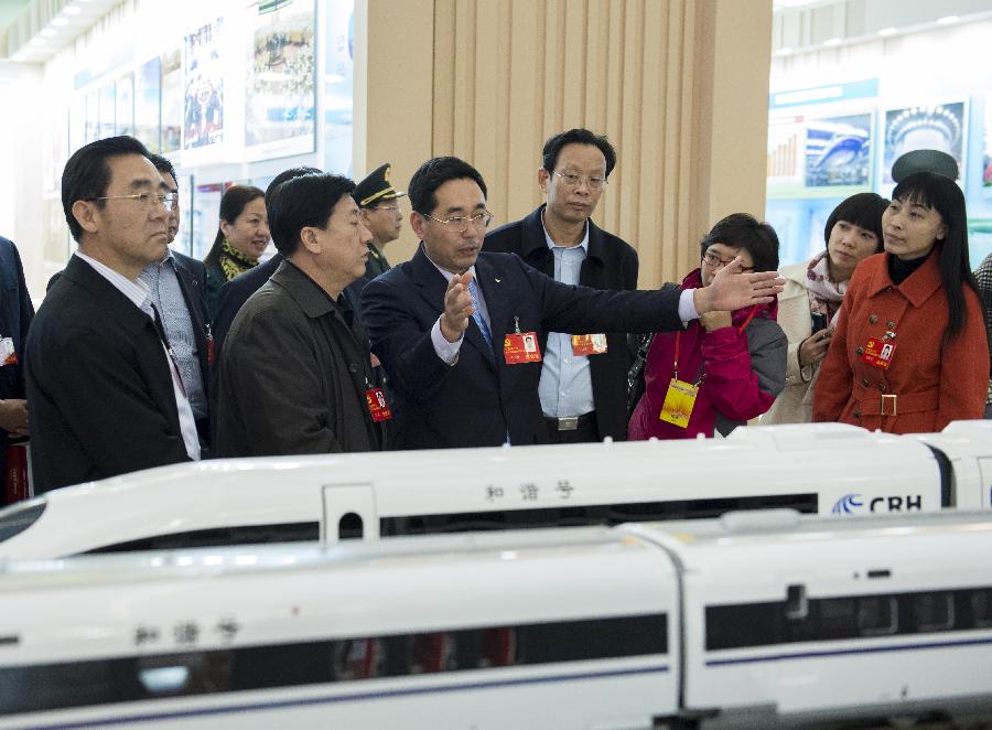 Delegates to the 18th National Congress of the Communist Party of China (CPC) visit a photo exhibition on achievements which China has gained under the leadership of the CPC, at Beijing Exhibition Center in Beijing, capital of China, Nov. 9, 2012.