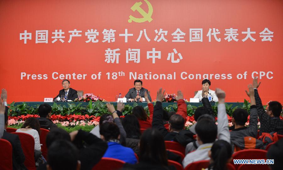 Chinese Minister of Commerce Chen Deming (C) receives interview at the press center of the 18th National Congress of the Communist Party of China (CPC) in Beijing, capital of China, Nov. 10, 2012.