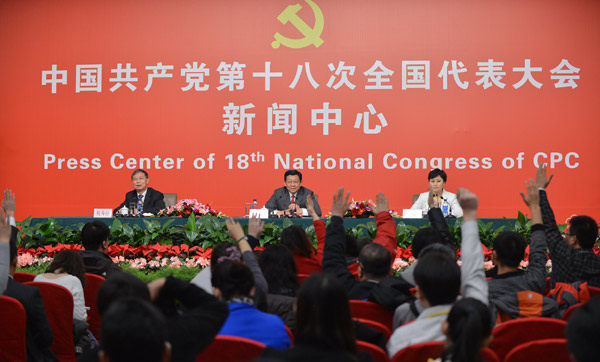 Chinese Minister of Commerce Chen Deming (C) receives interview at the press center of the 18th National Congress of the Communist Party of China (CPC) in Beijing, capital of China, Nov. 10, 2012.