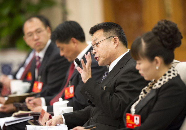 Hu Angang (2nd, R), president of the Institute for Contemporary China Studies of Tsinghua University, talks during a group discussion on the sideline on the sidelines of the 18th National Party Congress (NPC) in Beijing November 13, 2012. [Photo/Xinhua]
