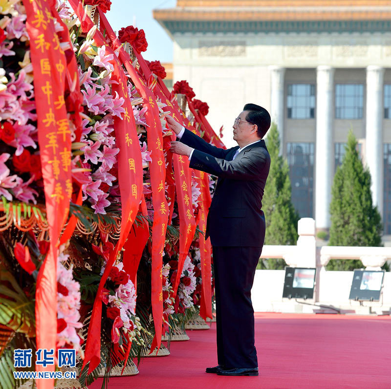 Party General Secretary, Chinese President, and concurrently Chairman of the Central Military Commission (CMC) of the CPC Hu Jintao carefully neatens the red ribbons on the flower baskets during a flower baskets laying ceremony at the Monument to the People&apos;s Heroes at Tian&apos;anmen Square in Beijing, on Oct. 1, 2012.