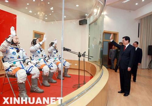 Chinese President Hu Jintao waves to Chinese astronauts (R-L) Liu Boming, Zhai Zhigang and Jing Haipeng who are set to board China's third manned spacecraft Shenzhou-7 for the spaceflight mission at the Jiuquan Satellite Launch Center in Gansu Province, on Sep. 25, 2008. 