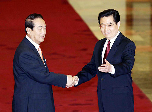 Hu Jintao (R), general secretary of the CPC Central Committee, shakes hands with James CY Soong, chairman of the People First Party (PFP) in Taiwan, at the Great Hall of the People in Beijing, capital of China, on May 12, 2005.