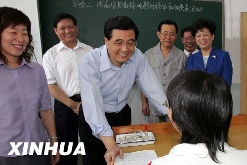 Chinese President Hu Jintao (Front Row, C) talks with a student at the Beijing Hongzhi Middle School, a charitable school which enrolls only financially-burdened students. On Sep. 10, 2004, the president inspected the educational operation conditions and visited teachers and students in Beijing on the 20th National Teachers' Day.