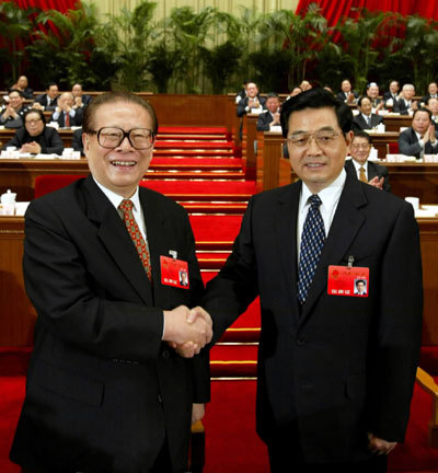 Jiang Zemin shakes hands with Hu Jintao (R), the newly-elected Chinese president at the first session of the 10th National People's Congress (NPC) at the Great Hall of the People in Beijing on Mar. 15, 2003.