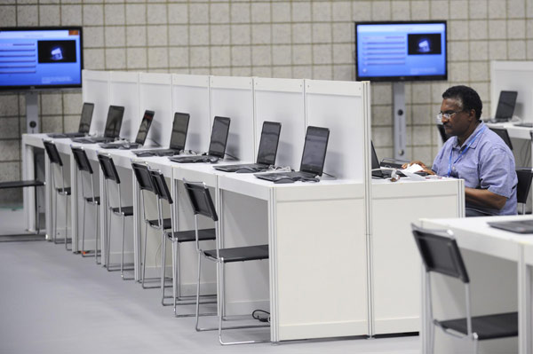 A reporter works in the media center of the Qatar National Convention Center in Doha on Nov 25, 2012