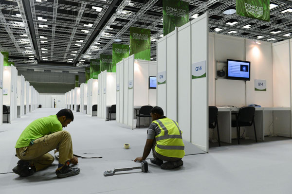 Staff work at the media center in the Qatar National Convention Center in Doha on Nov 25, 2012