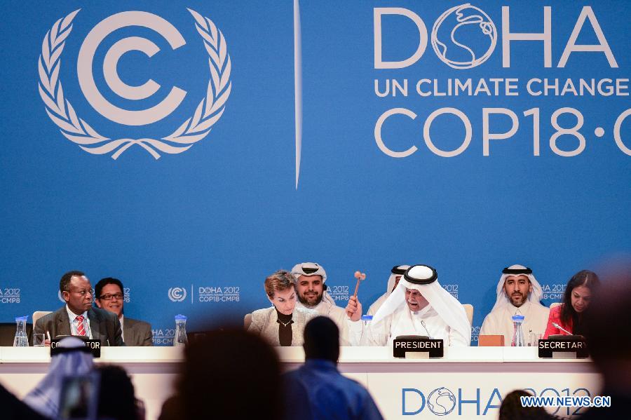 H.E. Abdullah Bin Hamad Al Attiyah (2nd R, front), President of the conference announces the final agreements of the UN Climate Change Conference (COP 18 and CMP 8) at the Qatar National Convention Center (QNCC) in Doha, Qatar, Dec. 8, 2012.