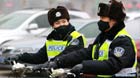 Two traffic policewomen with masks work in Jinan, capital of east China's Shandong Province, Jan. 30, 2013. The local traffic policemen used masks to protect their health in hazy days.[Xinhua]