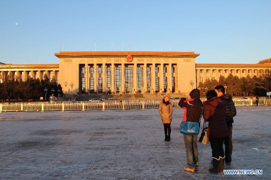 VVisitors pose for photos at the Tian&apos;anmen Square in Beijing, capital of China, Feb. 1, 2013.