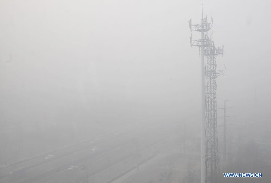 The city is blanketed by heavy fog in Shijiazhuang, capital of north China's Hebei Province, Feb. 27, 2013.