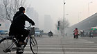 People travel amid heavy fog in Shijiazhuang, capital of north China's Hebei Province, Feb. 27, 2013.