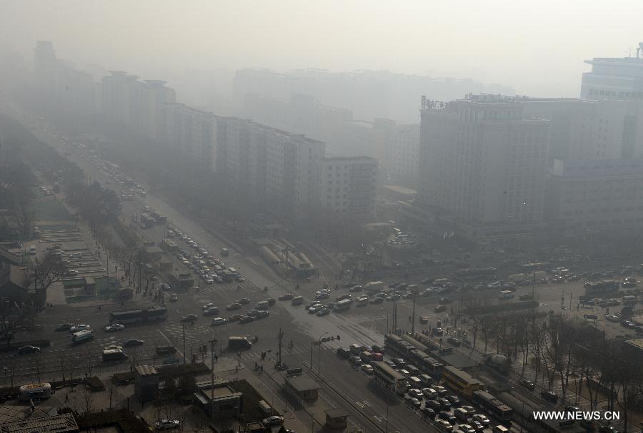 Fog and smog shroud streets and buildings in Beijing, capital of China, March 8, 2013. 