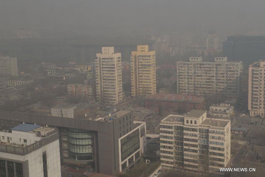 Fog and smog shroud streets and buildings in Beijing, capital of China, March 8, 2013. 