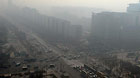 Fog and smog shroud streets and buildings in Beijing, capital of China, March 8, 2013.