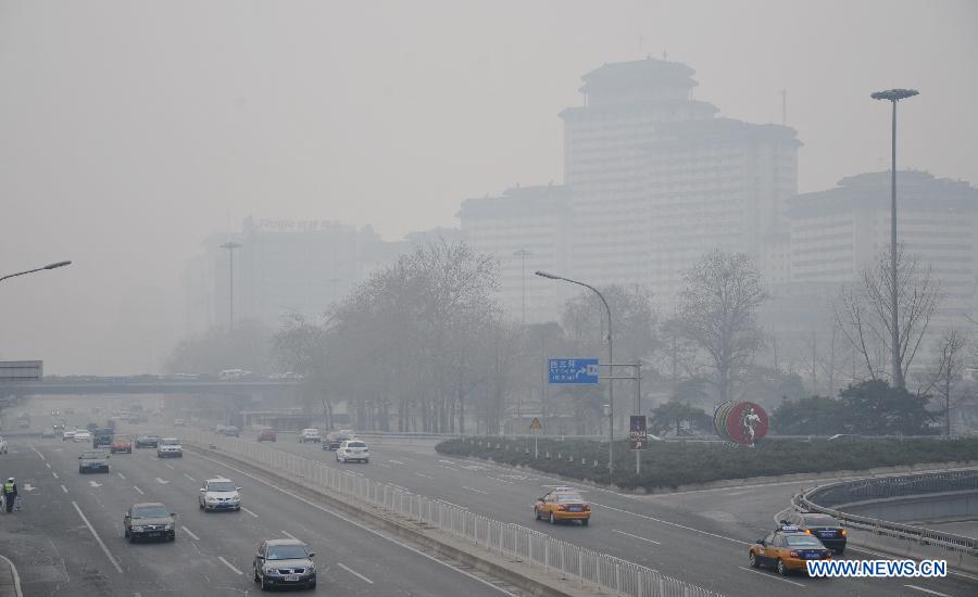 The fog-shrouded buildings are seen in Beijing, capital of China, March 17, 2013.