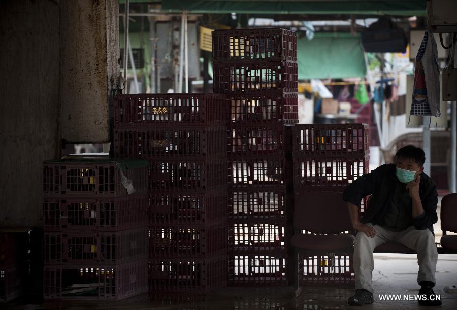 A worker rests at a live poultry market in Hong Kong, south China, April 8, 2013. 