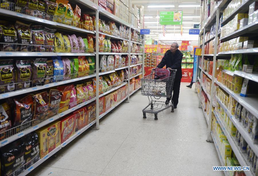 A citizen buys food at a supermarket in Changchun City, northeast China's Jilin Province, April 9, 2013. 