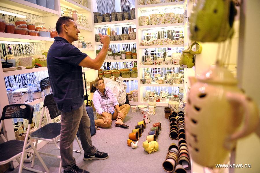 South African couple Tony Smily and Sally Smily purchases pottery at the 113th China Import and Export Fair, or Canton Fair, in Guangzhou, capital of south China's Guangdong Province, April 24, 2013. 